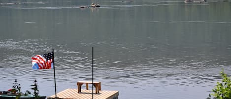 A view of our boat dock and kayakers enjoying the river.  Taken from our deck.