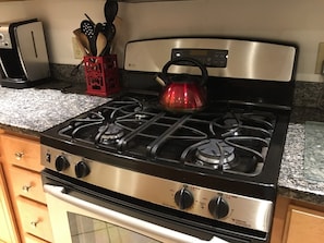 Kitchen with stainless steel appliances, granite counter tops, and tile floors.