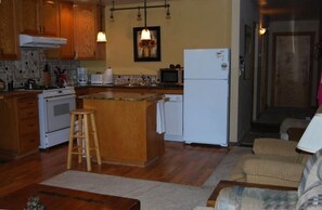 Kitchen with all the amenities and the bedroom at the end of the hall