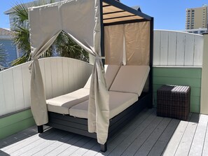 New oversized daybed for breezy naps/shaded relaxation on private upper balcony.