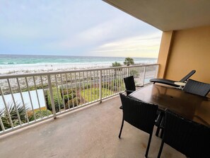 Gulf-front balcony view with plenty of seating for dining and relaxing.
