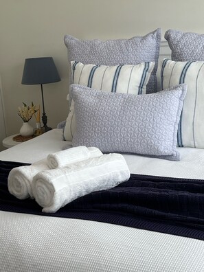 Main bedroom ~ Queen bed with crisp white linen and feather pillows