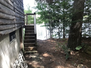 steps to lakefront deck from basement with lake access to the right of steps