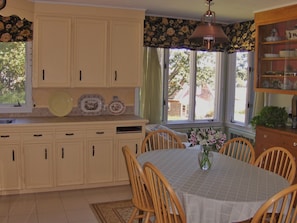 Kitchen Table Seats Six....brick, raised hearth fireplace out of view to right