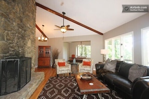 Main living room with stunning rock walls, wood burning fireplace and VIEWS!