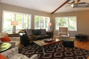 Main living room with amazing views, stunning rock wall with wood fireplace .