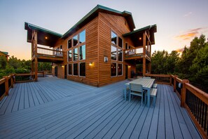 Large wrap-around deck with dining table and 12 stackable chairs