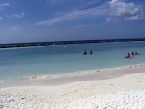 Sugary white sand, warm water with gentle to fun waves - not too rough- perfect