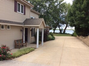 View of backyard and lake from large driveway.