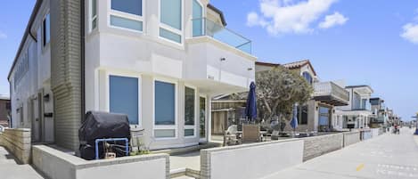 This lower level rental shares the property with a separate upstairs unit. Guests of this rental have access to the entire front patio, which looks out onto the pedestrian boardwalk and beach.