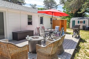 back deck with table chairs and umbrella