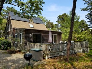 Large deck overlooks wooded lot