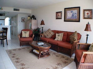 The living room has plenty of seating and a flat screen TV with digital cable.