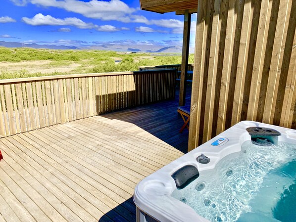 Hot tub out on the patio overlooking breathtaking landscape.