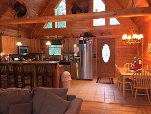 Open concept great room, kitchen, dining with cathedral ceiling