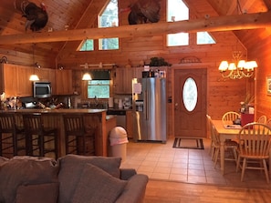 Open concept great room, kitchen, dining with cathedral ceiling