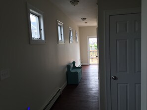 Hall leading to 1.5 bathrooms and in unit laundry