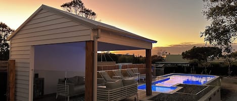 Sunrise over pool house and pool