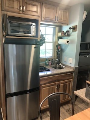 Kitchen w/fold down table (Frig, Oven, Microwave & Induction Burner)