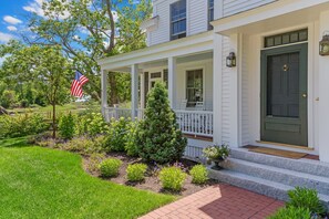 Front entry and front porch with rocking chairs.