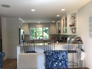 View from the dining room into the kitchen and bar area