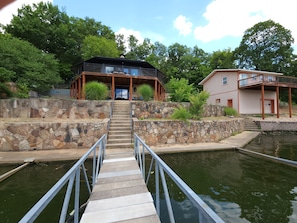 View of Octagon House (left) and studio (Peach house, top level) from the dock