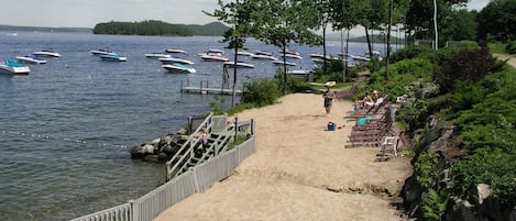 Sandy beach and waterfront with lounge chairs at Samoset.