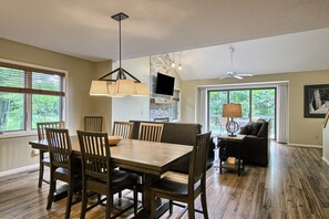 large dining table open into the kitchen and living room