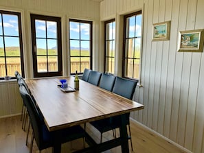 Lundur. Large dining table with beautiful nature views.