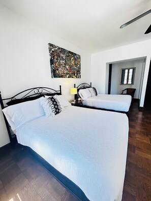 Two comfortable full beds with hotel sheets and lines