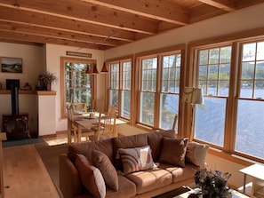 living room / dining area with views of the water and mountains