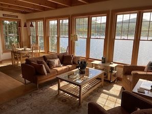 Sofa and two swivel chairs with dining table in background