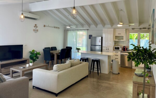 Open plan living and dining area with access to the fenced backyard.