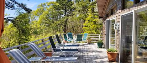 Large deck with outdoor furniture and wooded view