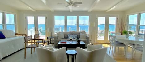 Beautiful sunroom with RH chairs and rug, West Elm sofa