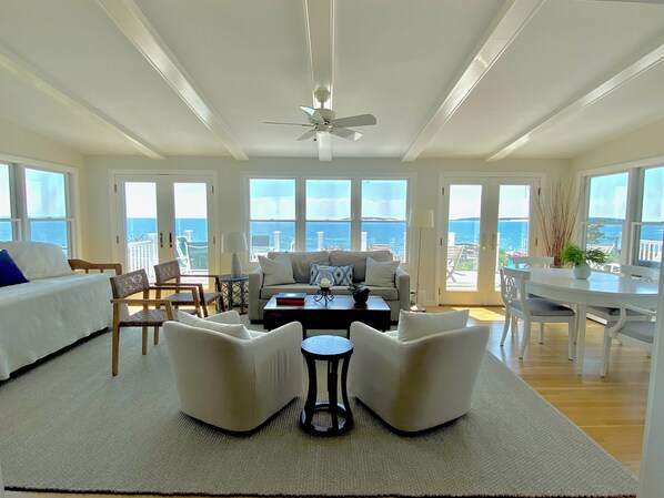 Beautiful sunroom with RH chairs and rug, West Elm sofa