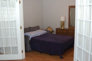 Opened sofa bed with French doors in Master Bedroom.