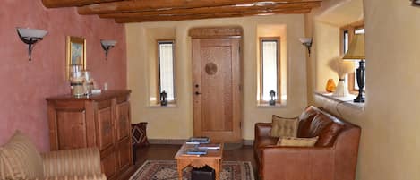 Living room with Spanish colonial furniture and door - original vigas