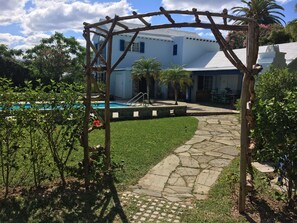 Our entrance - electric car charger is just to the right of the trellis .... 
