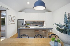 View of kitchen and dining pod. Bosch appliances and caeserstone benchtop