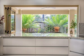 Six Beachside Port Douglas:  Huge Kitchen opens up to outdoor dining area