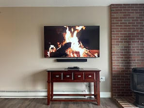 75" smart TV with surround sound system.