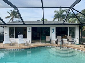 From the pool you can see into the Florida Rm through the windows & sliding door