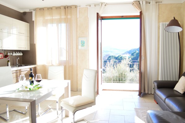 Living room with full equipped kitchen and balcony