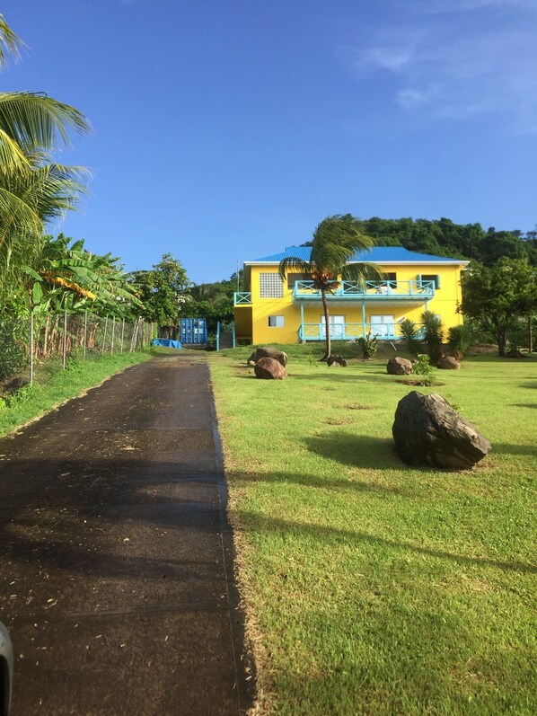 View from bottom of driveway/walkway.  The WINDWARD is on the lower level.