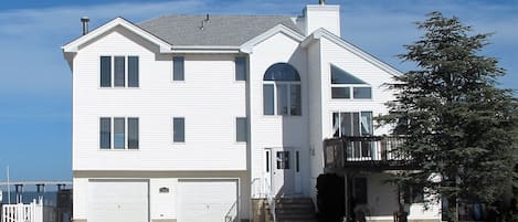 Street view from the front of the house. Notice the bay and causeway.