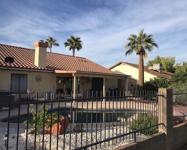 A beautiful back yard awaits you with pool, hot tub and a golf course view 