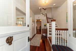 Entry hallway and stairs, kitchen at end