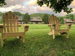 Local-crafted Adirondack chairs, by the riverbank directly in front of cabin