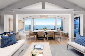 Open floor plan with family room, dining, and kitchen all facing ocean views 
